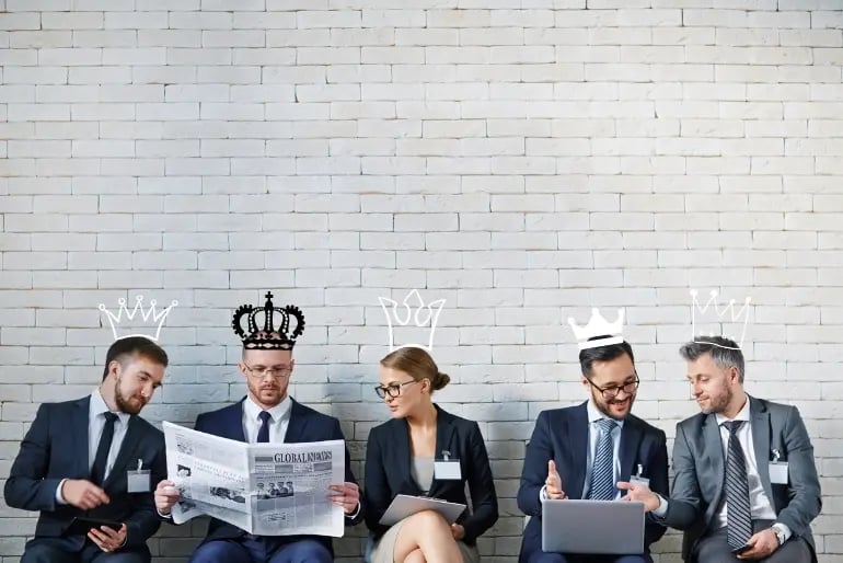 business people wearing crowns