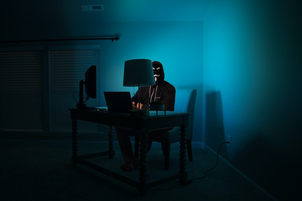 Hacker sitting in a darkened room