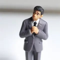 Miniature plastic model man looking hesitant